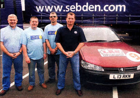 Paddy Milligan and Gerard Larkin (Centre) who are taking part in the Scally Rally Ireland for Marie Curie Cancer Care receiving a donation of £250 from (Left) Mark McAusland of Sebden Steel and (Right) Malcolm McComb of Donnelly transport- US411O-124A0