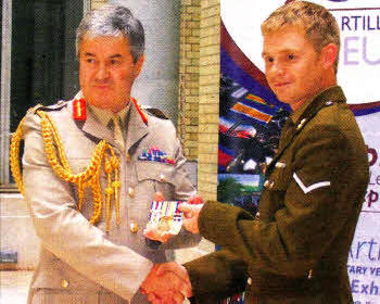 Lance Bombardier Prout presents his medal group to General Barrons.