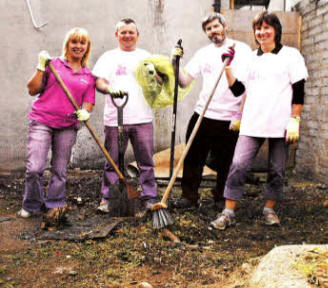 Hilary Scott, Retail Development Manager, Ulster Cancer Foundation (UCF) congratulates BT volunteers Paul Logue, Peter Breen and Lynda Rainey who cleared up the yard at UCF's charity shop, 21 Antrim Street, Lisburn.