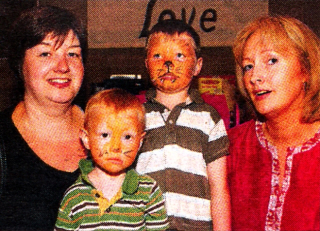 Elaine Williams with her sons Matthew and Daniel and Janet Moreland at Trinity Methodist Church Pretty ln Pink Breast Cancer Awareness Fundraising Day. US2710-112A0