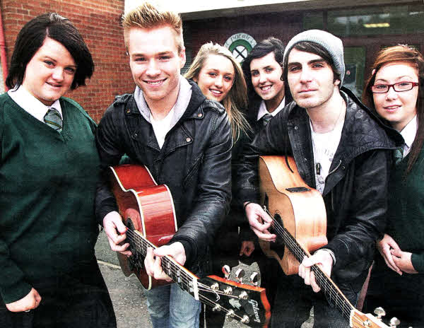 Danielle Graham, Natasha Loughran, Rachel Gourley and Catherine Dunleavey with Australian singer Sam Clark (who played Ringo Brown in Neighbours) and guitarist Peter Vlanes, who are currently touring Northern lreland. Sam met pupils from St Patrick's Academy, performing for the whole school, taking part in a Q&A session and signing autographs. Sam has twice topped the Australian music charts with the singles Broken and Devastated. US381O-514cd