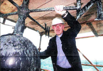 Rector Canon Sam Wright at the top of the Cathedral with the capsule.