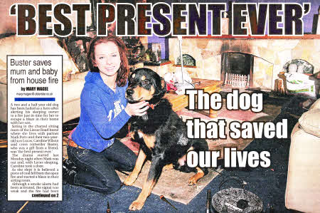 Caroline and her dog Buster in the burnt-out living room of her house at Lissue Road, Lisburn.