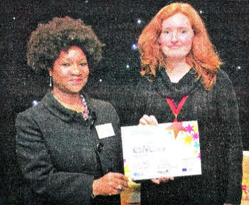 Carol Duffy receives her award for third place in the photography category of the British Council and Ecorys competition for participants of the Lifelong Learning Programme and Youth in Action from Althea Warner from the Department for Education.