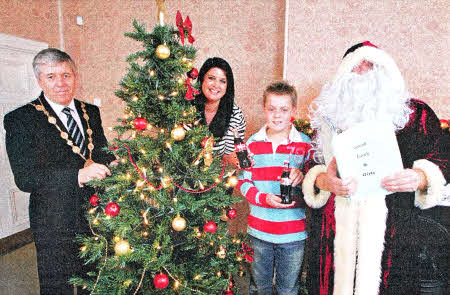 Master George Boyde helps to launch the 2011 Lisburn Christmas Switch On. To mark the theme of this year's event, `Twas the Night Before Christmas, George is joined by Mrs Gillian Shields from the event sponsor Coca-Cola HBC Northern Ireland; the Mayor of Lisburn, Councillor Brian Heading and Santa Claus.