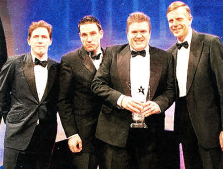 David Gibson, (second right) receives his award for Most Innovative Teacher at the Times Higher Education Awards. Also pictured are (L-R) Rob Brydon, Paul Ramsden, judge and former head of the Higher Education Academy and Queen's Vice-Chancellor Professor Sir Peter Gregson.