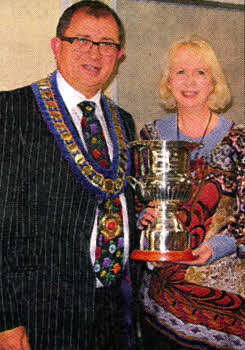 Sam Baird, performing one of his last duties as chairman of Dromore Beekeepers' Association in presenting the 'Senior Biology Cup' from Dromore Beekeepers' Association to Hazel Uprichard, the head of Science at Dromore High School. This is to recognize that Dromore High School has now a sixth form department and is preparing 26 students for A level Biology.