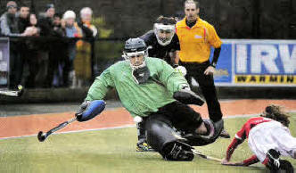 Lisnagarvey goalkeeper John Tormey saves from Greg Allen of Cookstown.