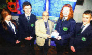 Fort Hill College pupil Natalie Davis presents a gift and donation to Holocaust survivor Mr. Harry Bibring.