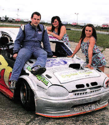 Recently crowned National Champion Shane Murray of Randalstown, seen here with Nuttscorner girls Paula Currie and Haley Bevan, will be a top contender for the World Championship at Nuttscorner Oval on July 23/240