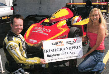 Katie Barber, Miss Superkart from Portadown helping Llsburn's Liam Fox, the defending NI champion, get ready for the Kart Grand Prix.