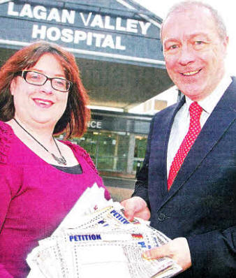 Julie-Ann Spence from the Ulster Star presenting the petitions to Director of Hospital Services, Mr Seamus McGoran. US4911-108A0