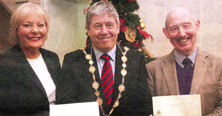 Receiving a cheque from the Mayor of Lisburn, Councillor Brian Heading are Mrs. Pamela Neill, The Salvation Army and Mr Joe Maguire, St Vincent de Paul