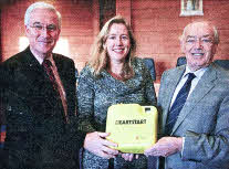 Alderman Jim Dillon presents a defibrillator to Aisling Owens, Chief Executive of Lisburn Enterprise Organisation alongside Adrian Donaldson, Director of Corporate Services, Lisburn City Council.