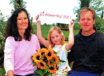Sunflowerfest event directors Vanessa and Michael Magowan join seven-year-old Juliet Shaw down at Tubby's Farm for the launch of Sunflowerfest 2011