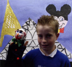 Neil Toole P7 exhibits his puppet Zappy in front of the backdrop for the end of term Puppet Show 2007.