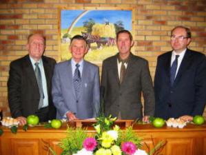 L to R: Norman Moore, David Adams,John Martin and Desmond Shortt. In the background is a painting by the late Jack Calderwood, showing a harvest scene.