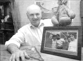 Former boxer John Rodgers at home with gloves from Madison Square Gardens and a precious picture showing him with legend Mohammad Ali US09-406PM