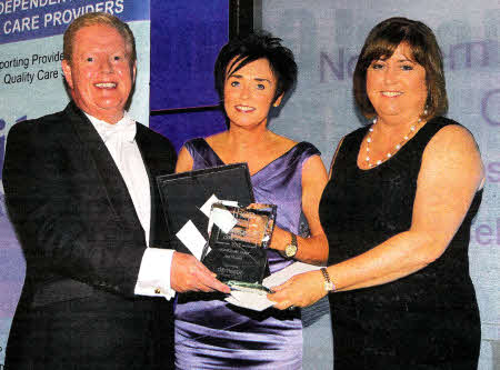 Ann, having won her award, alongside Julian Simmons and a representative of the Domiciliary Carer award sponsor, Domestic Care