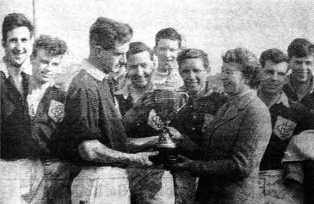 Lisnagarvey Hockey Club created a record in April, 1958 when they won both the Irish Senior Cup and Junior Cup on the same day. The Firsts defeated Dublin University 2-0 at Cliftonville while the Seconds defeated YMCA Seconds 1.0 in Dublin. Our picture shows Firsts captain Steven Johnston receiving the Senior Cup from Mrs. W.A. Shooter.