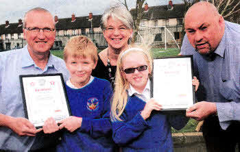 Jack Malcolm and Megan McNeill, with postman Liam Redman, principal Mrs. Sharon Shanon and Lisburn Delivery Office, Manager Davy Mack.