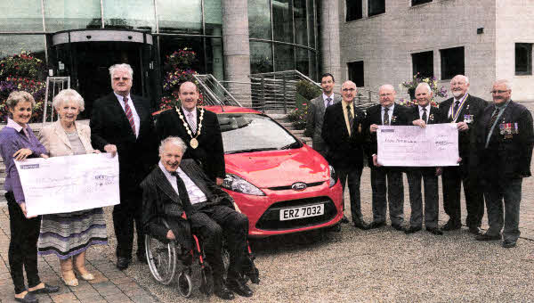 Pictured with the Mayor, Alderman William Leathem are (14); Prize Draw Winner, Mrs Camilla Coles; The Lord Lieutenant of County Antrim, Mrs Joan Christie, OBE; Former Councillor, Mr Ned Falloon and Representatives of the SSAFA and The Royal British Legion. 