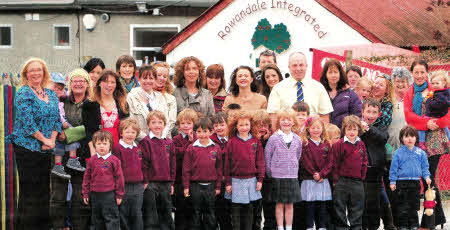 Pictured outside Rowandale Integrated Primary School are Alderman James Tinsley, Chairman of the Council's Planning Committee, along with parents, teachers and pupils from the school who are looking forward to welcoming Roads Service reduction to the speed limit in the area.