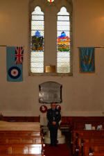 Flt Lt Roy Kerr (OC 817 Lisburn ATC) pictured at the memorial window in Eglantine Parish Church.