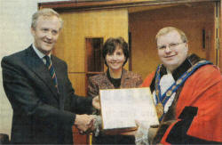 The Mayor, Councillor Jonathan Craig and Mayoress Yvonne Craig present Colonel Mark Campbell with a gift and cheque for the Benevolent Fund of the Royal Irish Regiment. US21-751SP