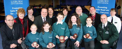 The winning team from Meadow Bridge Primary School L to R: Bethany Henry, Danielle Davis, Thomas Latimer, Katie Walker and Lauren Tate. (back row) John Palmer (LRSC Treasurer), Patricia Cromie (LRSC), Karen Mawhinney (National Standard Cycle Instructor), Paul Good (Principal), Patricia England (LRSC), Councillor Jennifer Palmer, George Cromie (LRSC Secretary), Andrew Ewing (LRSC Vice Chairman), Constable Stevie Wright (Hillsborough RPU) amd Sergeant Joanne Gibson (Community Liaison - PSNI).