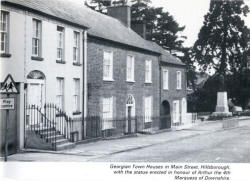 Georgian Town Houses in Main Street, Hillsborough, with the statue erected in honour of Arthur the 4th Marquess of Downshire.