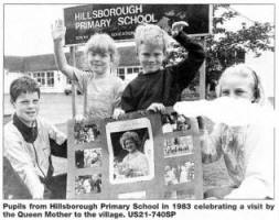 Pupils from Hillsborough Primary School in 1983 celebrating a visit by the Queen Mother to the village. US21-740SP