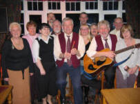 Drew Rowan (left) and Noel McMaster of Bakerloo Junction pictured at the Ivanhoe Hotel in February 2006 with some of today�s older generation of folk music enthusiasts.
