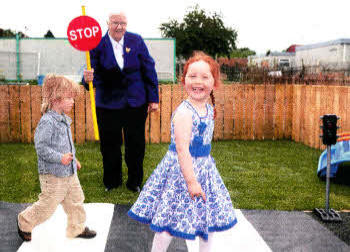 Baroness May Blood sees Ethan Foster and Caltriona Lynch safely Into Rowandale Community Playgroup which she officially opened. Baroness Blood is Campaign Chair of the Integrated Education Fund which gave a grant to support the opening of the new preschool facility. Pic by Declan Roughen.